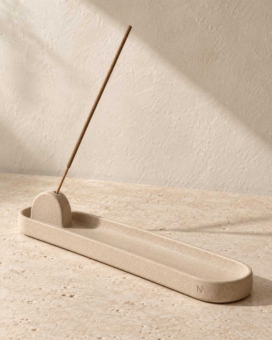 NOSTOS concept incense arch, photographed on warm limestone.