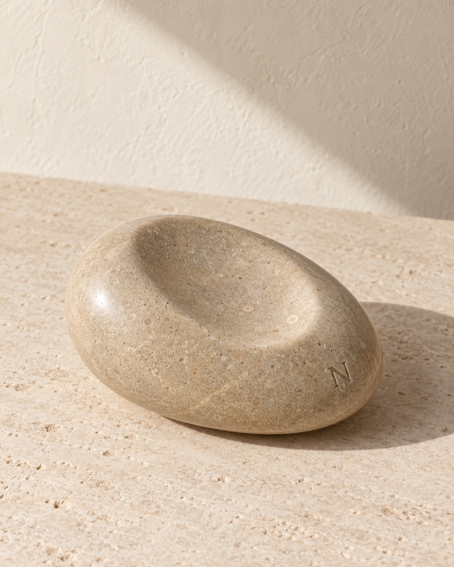 NOSTOS concept palm stone, photographed on warm limestone.
